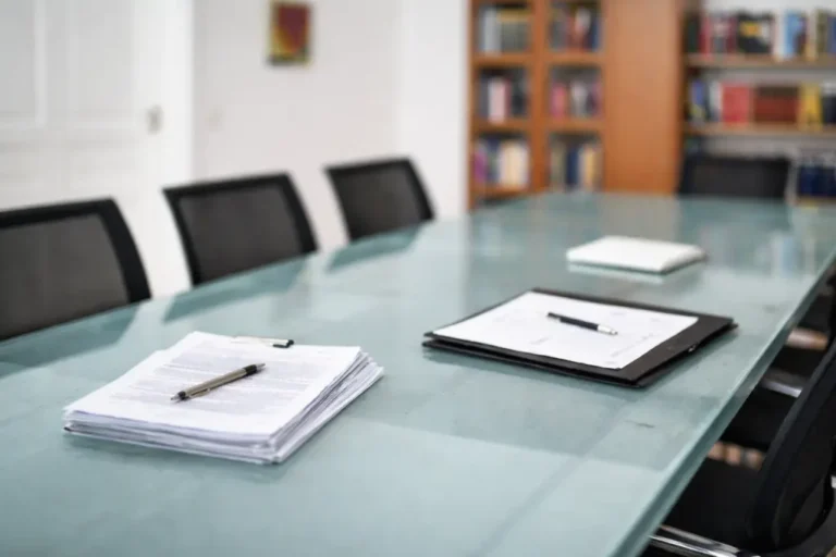 Documents on the conference table for the review of the compensation claim.